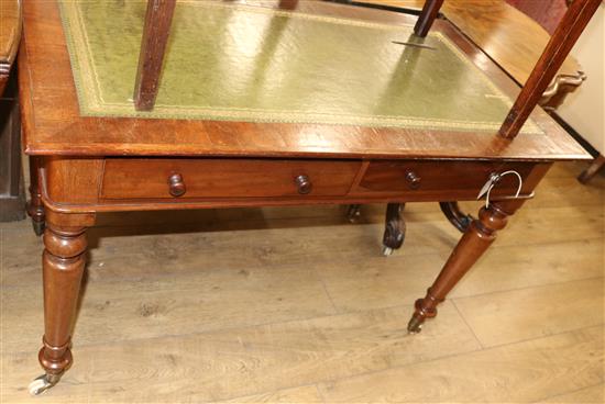 A Victorian mahogany two drawer writing table, with green leather inset top W.111cm